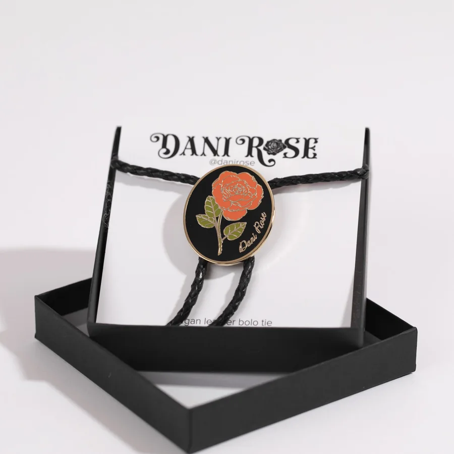 Dani Rose bolo tie with an enamel rose on a braided cord, in its gift box